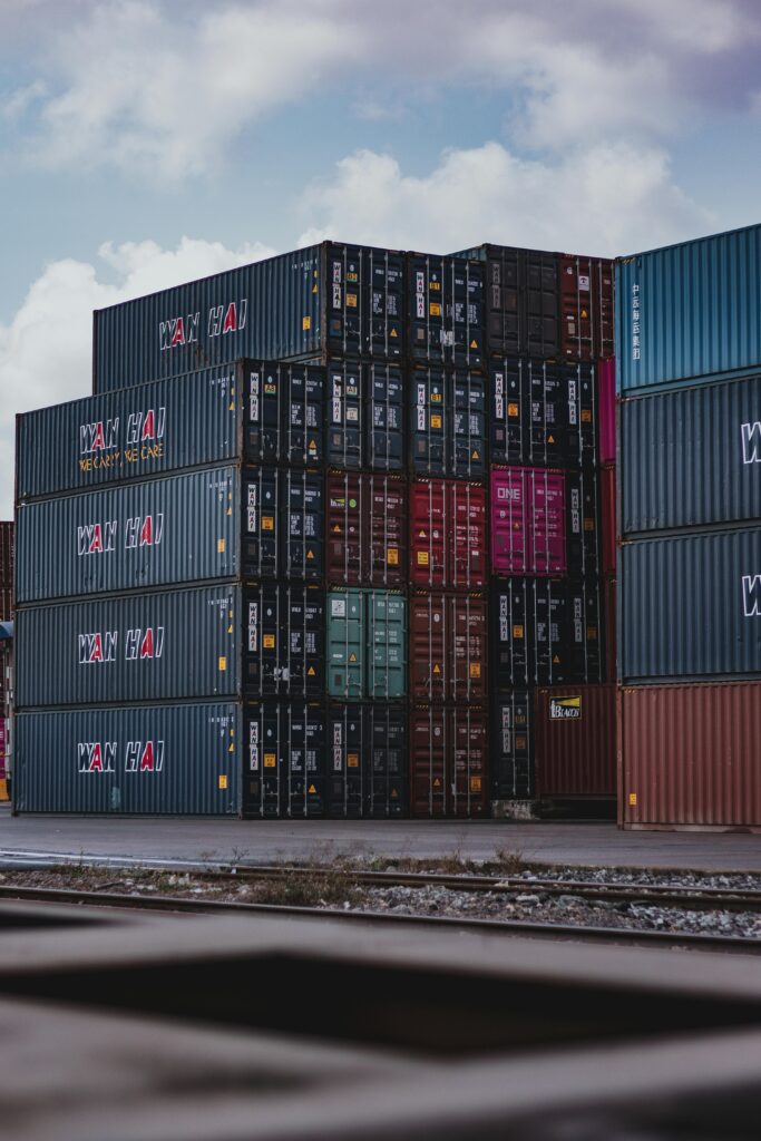 pexels-photo-3735930-3735930 High vertical stack of cargo containers at a port, symbolizing global logistics.