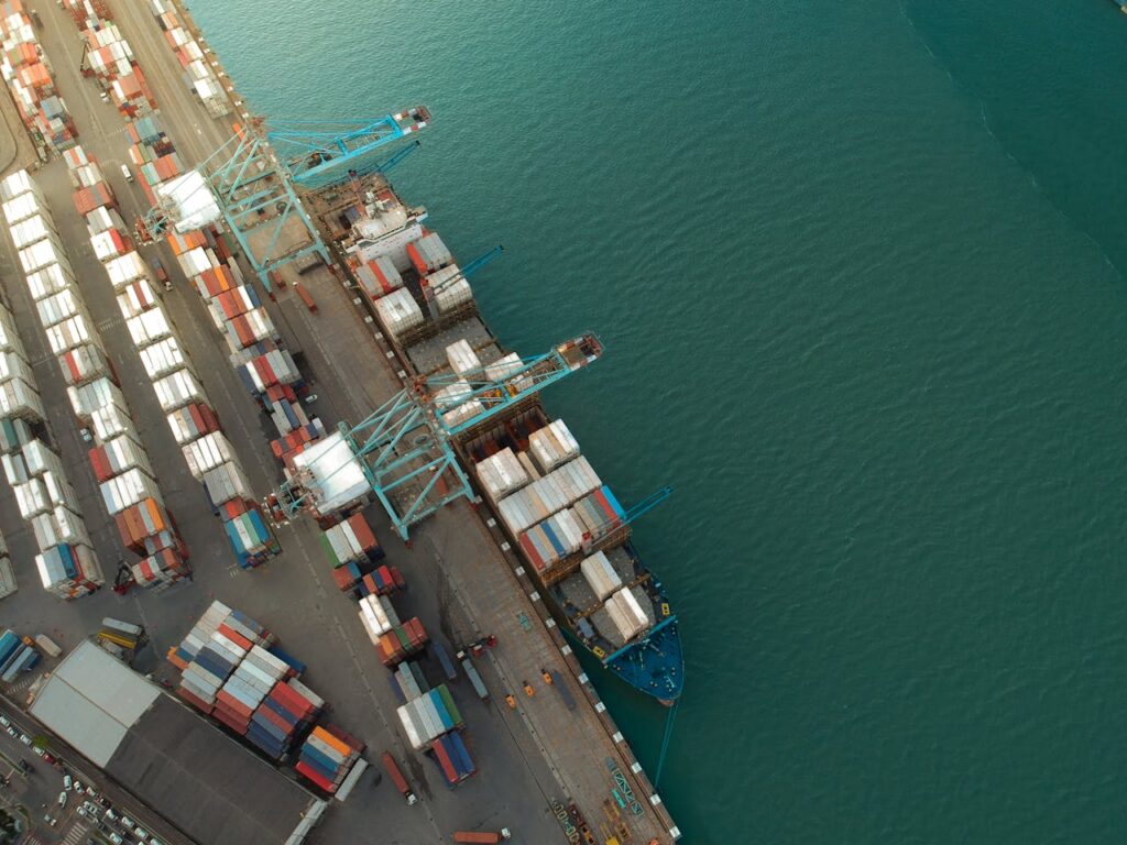pexels-photo-4256976 Top view of harbor with containers and cargo ships located near calm rippling sea water